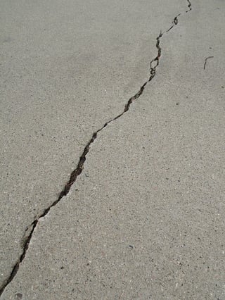 why do concrete floors crack